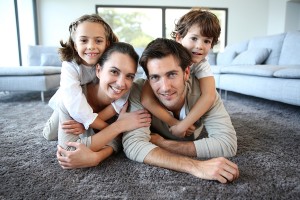 Family at home relaxing on carpet